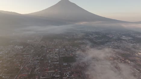 wide view of antigua city at guatemala during foggy morning, aerial