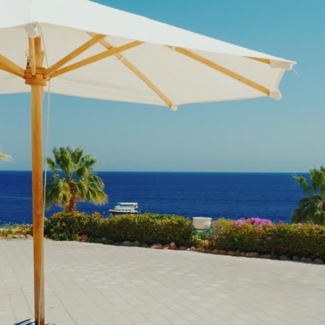 a row of white umbrellas against the blue sky in a luxury hotel 2