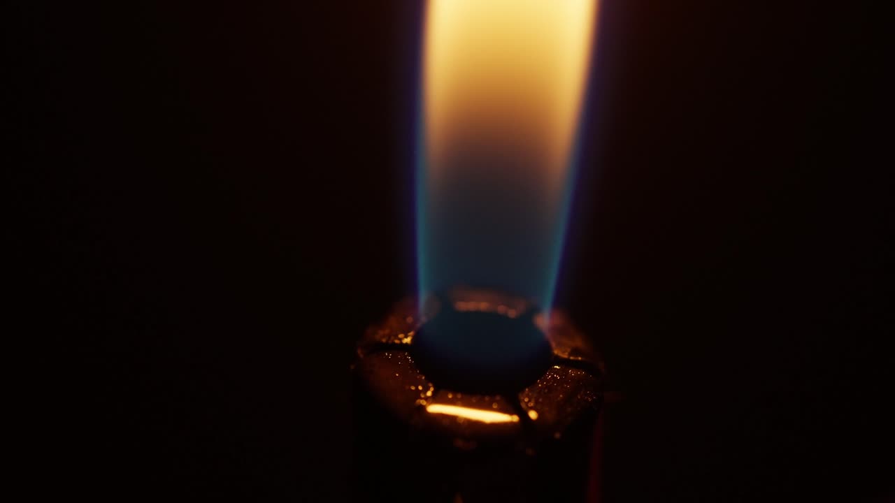 macro shot of a flame igniting out of a lighter, fire on a black background