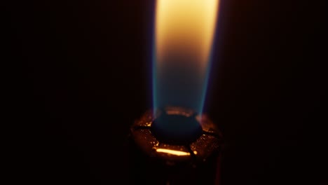 macro shot of a flame igniting out of a lighter, fire on a black background