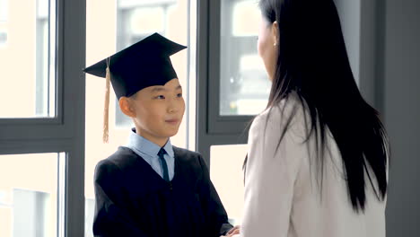 kid holding hands with his mother