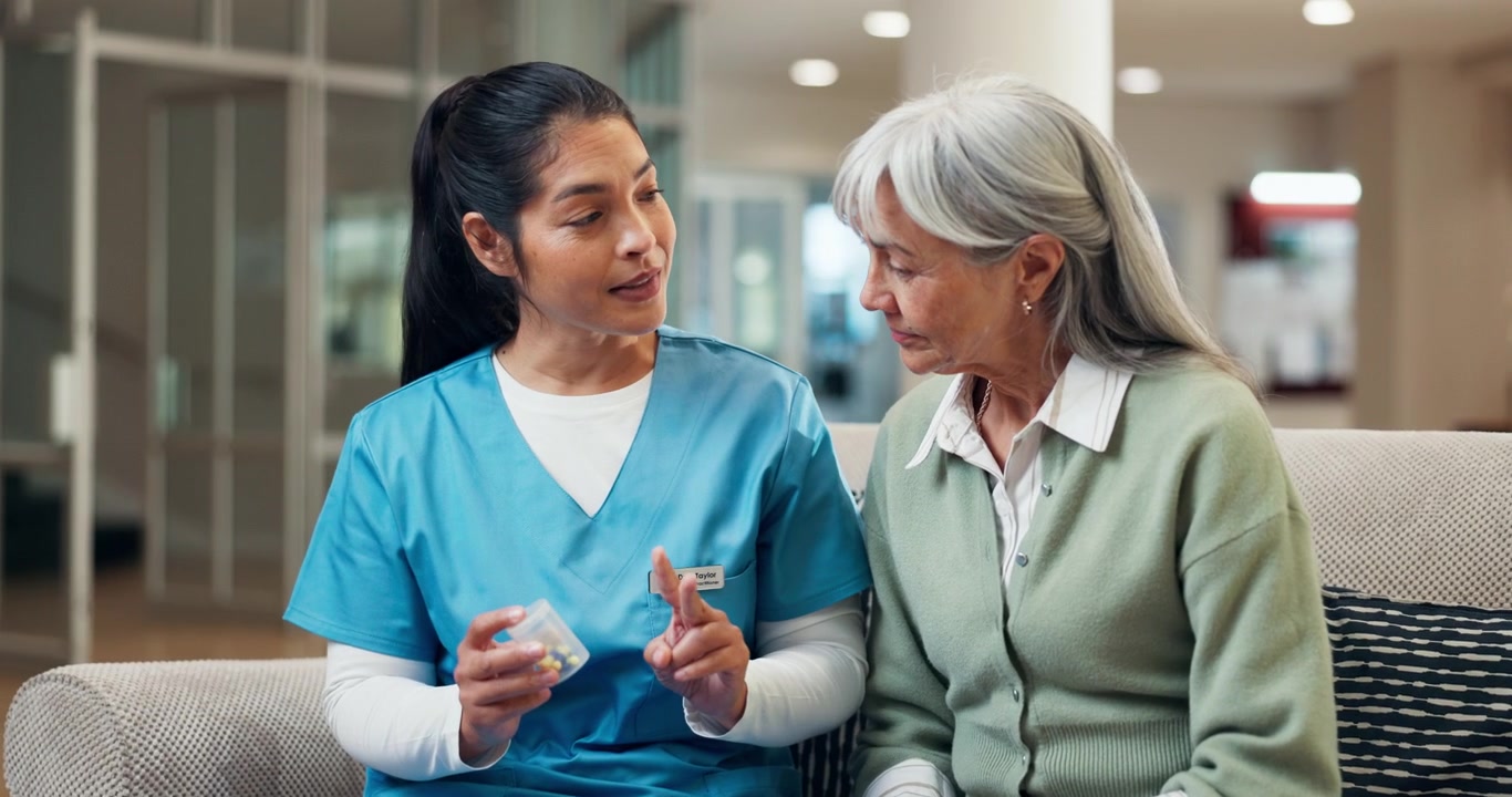 Nurse Explaining Medication to Senior Patient in Care Facility