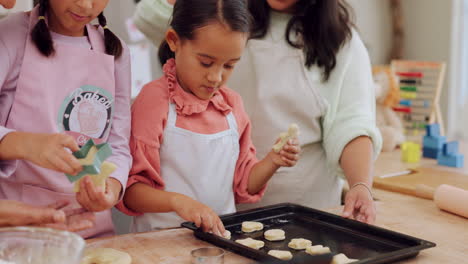 grandma, mom and kids learning baking in a home