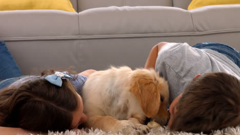 happy siblings with their puppy at home