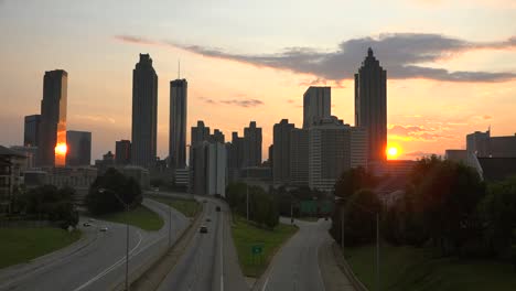 the sun sets behind the skyline of atlanta georgia 1