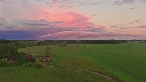 Lonely-farmhouse-surrounded-by-agricultural-fields,-aerial-drone-view