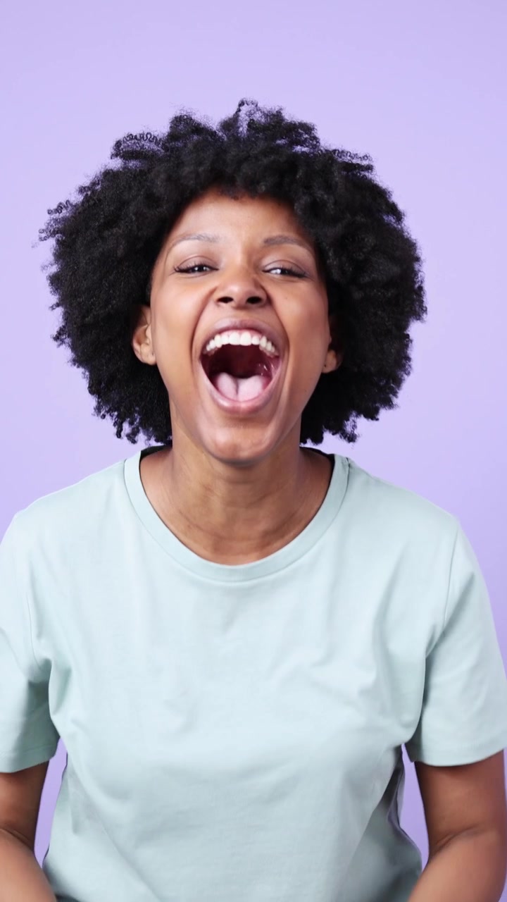 Young Black Woman Reacting with Surprise, Excitement, and Laughter