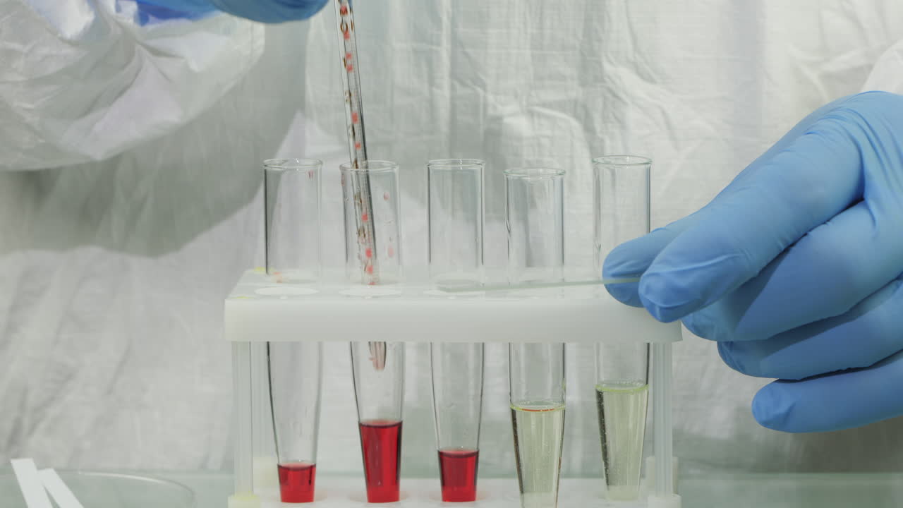 Technician drop blood in test tube 5