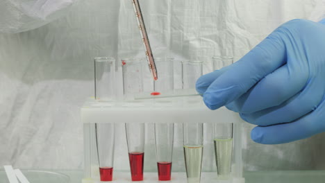 Technician-drop-blood-in-test-tube-5