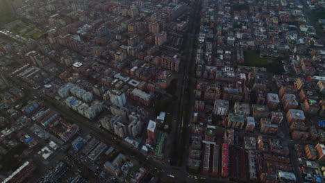 cinematic panoramic view of city during morning dawn with orange buildings, city streets, and main avenue