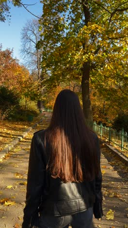 woman walking in autumn park