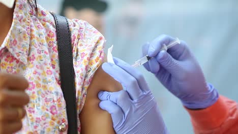 close-up video of a woman's arm being injected with the corona virus vaccine