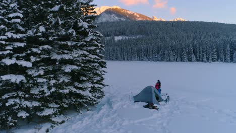 couple embracing near the tent on snow covered landscape 4k