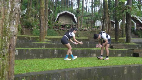 runners stretching in a forest campground