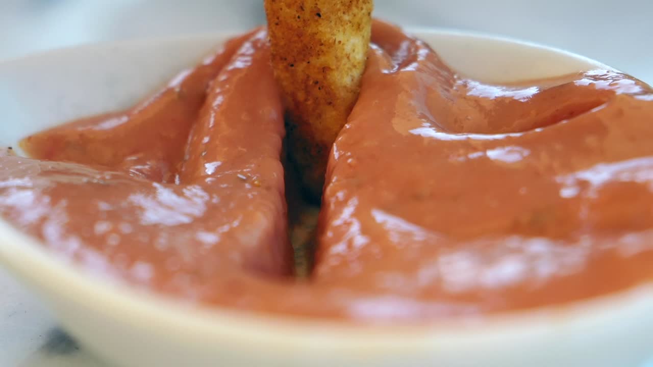 French fry dipped in ketchup