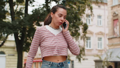 irritated stressed business woman talking on two mobile phones having conversation conflict quarrel