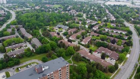 flying towards mississauga apartment buildings and houses on an overcast day