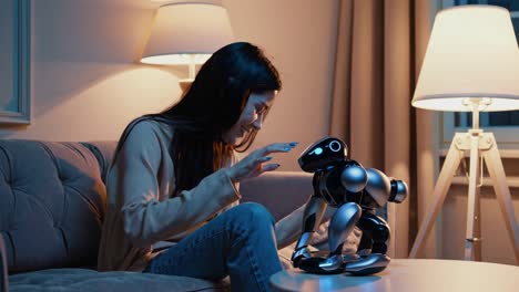 woman interacting with a robot toy in a living room