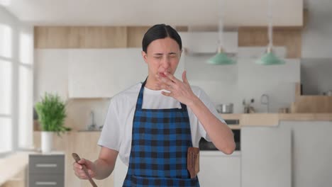 indian housewife tasting spicy food