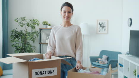 woman donating clothes and household items