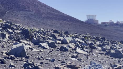 Cinematic panning shot of the barren rocky landscape near the Haleakala Observatory at the summit of Haleakala in Maui, Hawai&#039;i