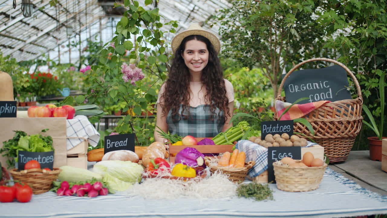 Woman at a Fresh Produce Stand in a Greenhouse