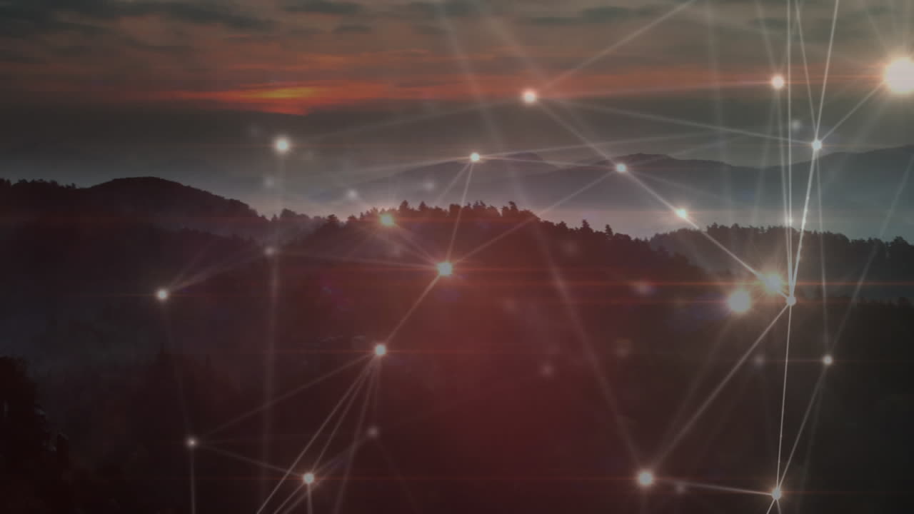 Animation of glowing network of connections moving over sunset landscape