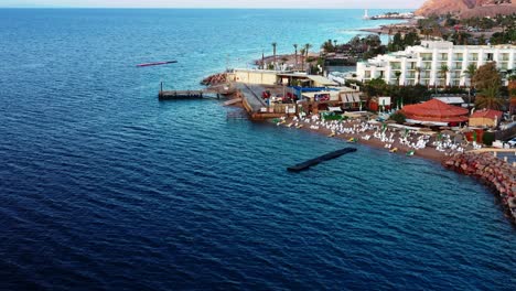 flying over a modern boutique, red sea beach resort in eilat israel in golden light