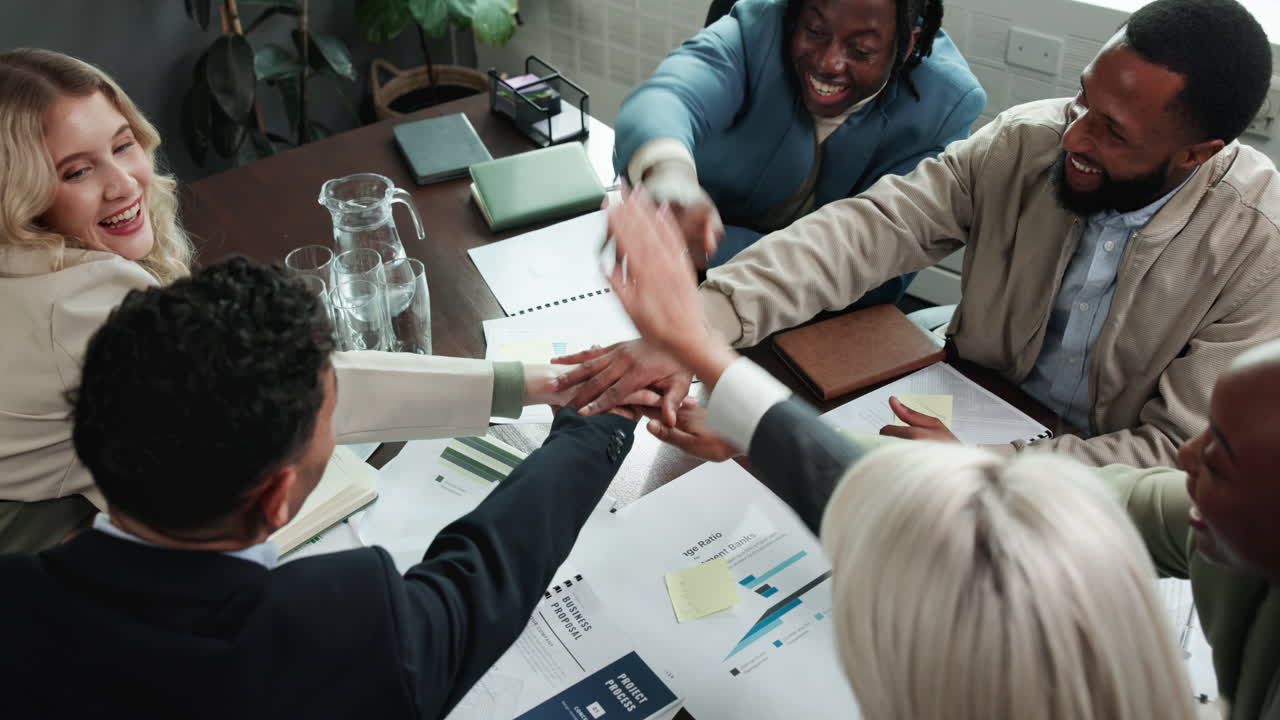 Successful and diverse business team celebrating achievement in a meeting