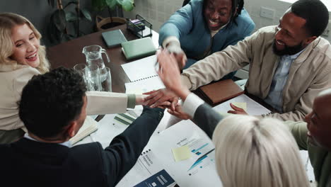 successful and diverse business team celebrating achievement in a meeting