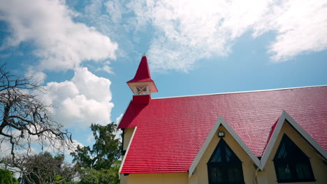 panoramic shot of small wooden church with red rooftop