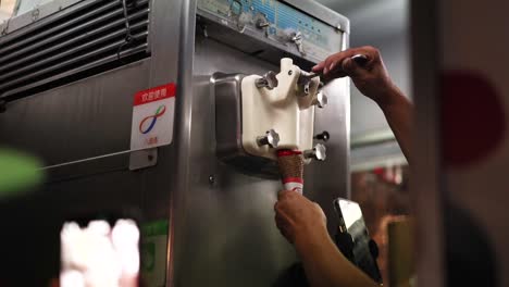 hands operating an ice cream machine