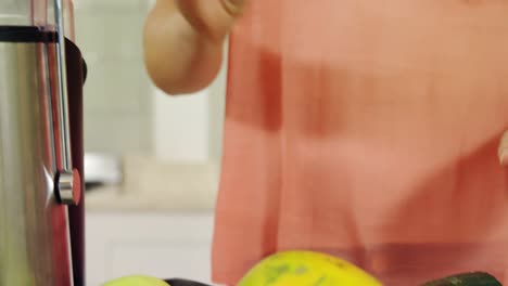 Woman-preparing-vegetable-smoothie