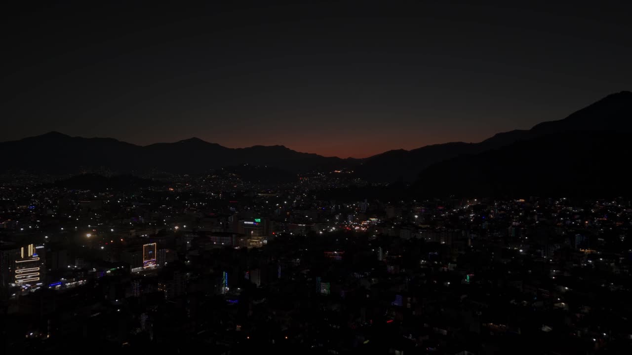 Aerial night footage of Kathmandu city during Diwali (Tihar), featuring the illuminated Dharahara Tower and glowing skyline filled with festive lights, showing Nepal’s vibrant cultural celebration