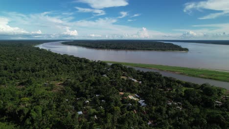 aerials shot of the dense amazon forest and settlements in colombia