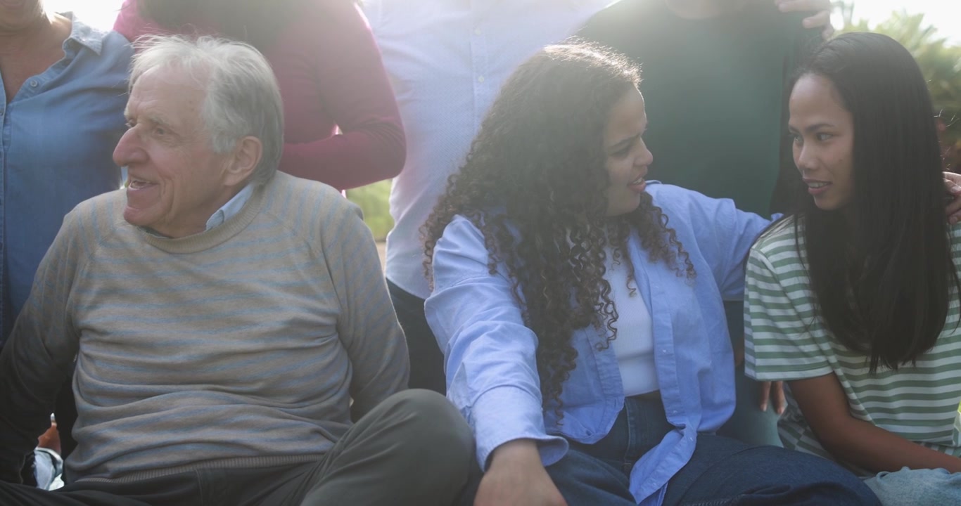 Multi-Generational Group of Diverse People Talking and Laughing Outdoors