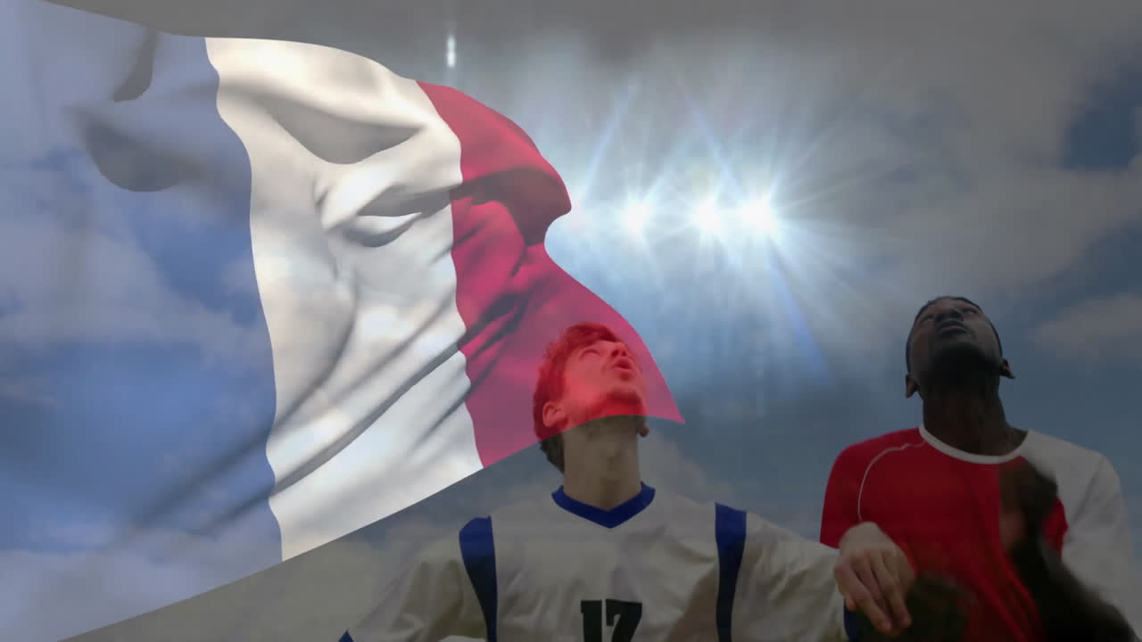 Waving French flag, soccer players looking up with animation in background