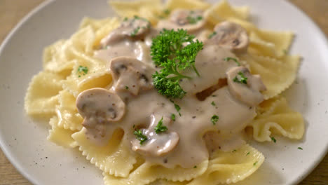 farfalle pasta with mushroom white cream sauce - italian food style