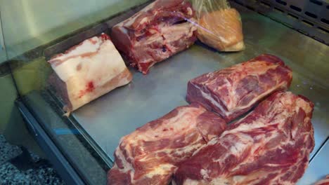 closeup shot at raw red meat cut in a store fridge display