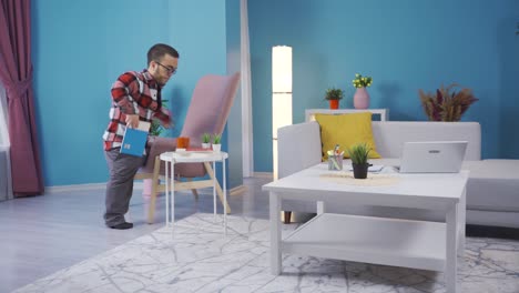 Young-man-with-dwarfism-is-reading-his-book-on-the-sofa-at-home.