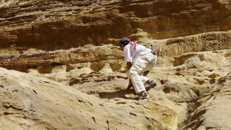 person climbing rocky mountain