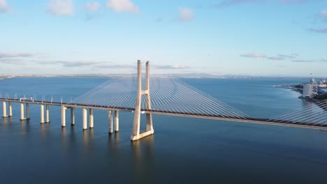 aerial side panning shot of vasco da gama bridge in lisbon, portugal