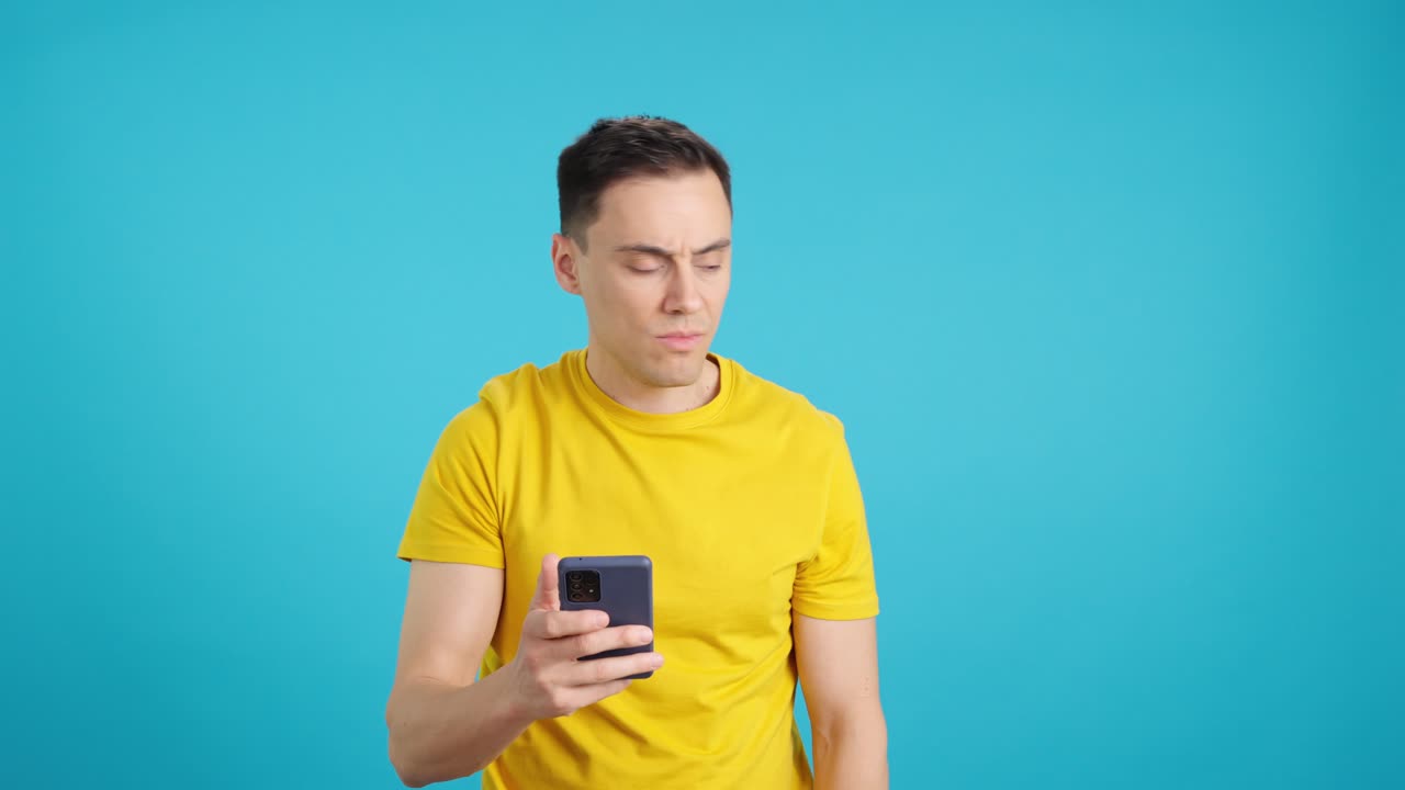 Man looking at his phone with a concerned expression