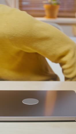 young person working on laptop