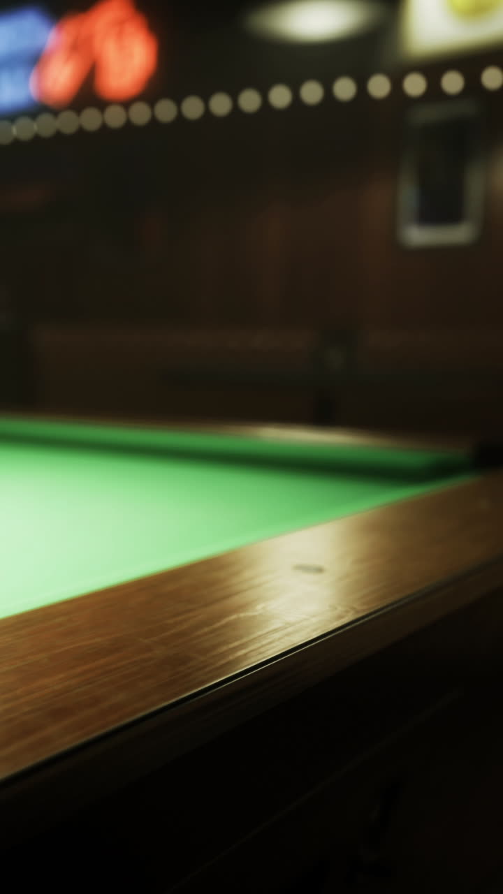 Exciting moments unfold at the green felt pool table in the cozy bar