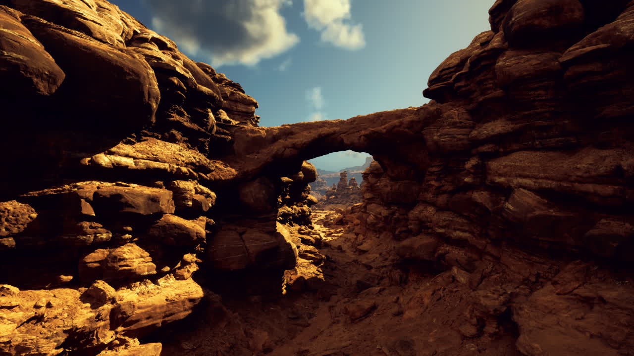 Natural rock formation with arch in a desert landscape under blue sky