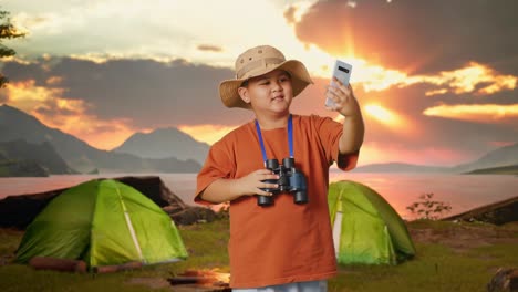 Boy Taking a Selfie While Camping