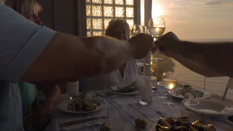 people toasting during dinner on the balcony