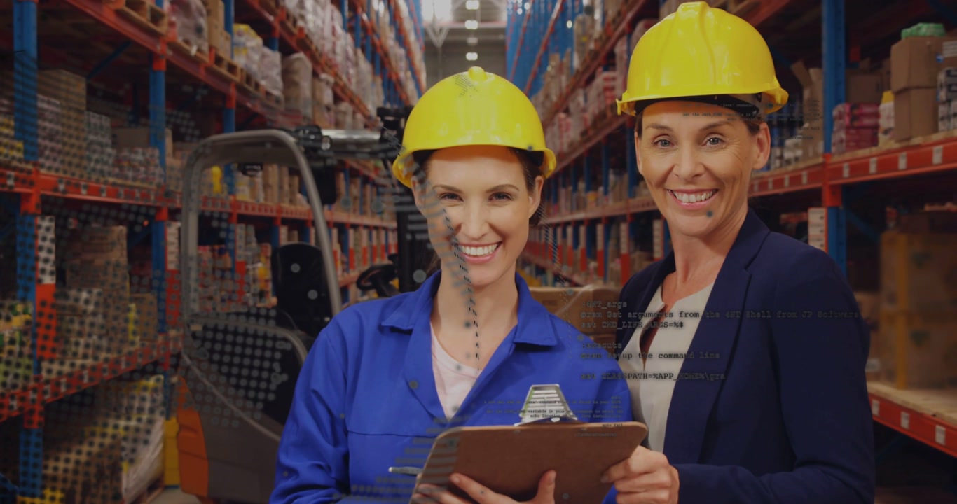 Female coworkers in hard hats clipboard checking stock at warehouse as dot shifting revealing racks