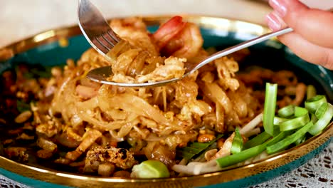 savoring delicious pad thai with shrimp